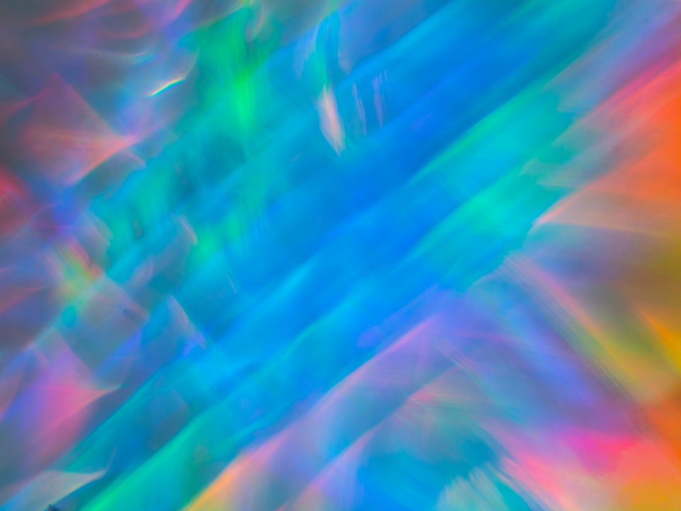 Abstract background featuring vibrant, colorful light patterns blending seamlessly.