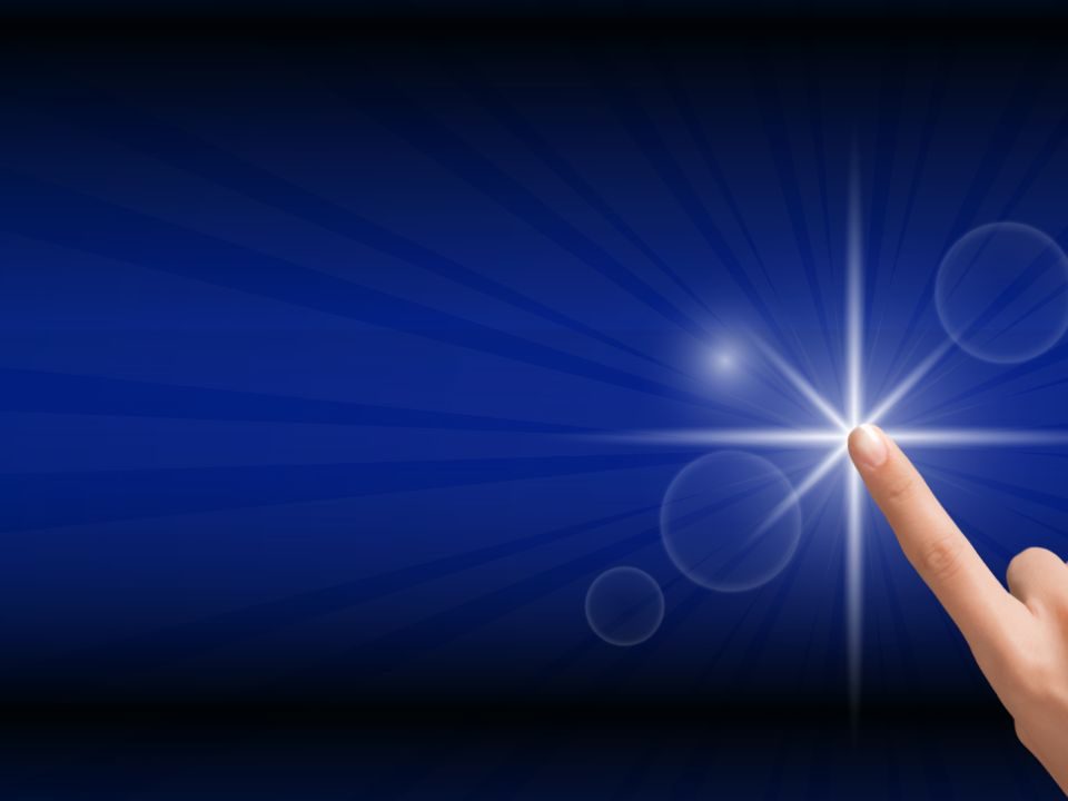 A hand pressing a button that looks like a bright white star against a vibrant blue background