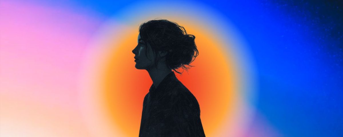 The silhouette of a young woman with an orange color aura on a pink and blue background.