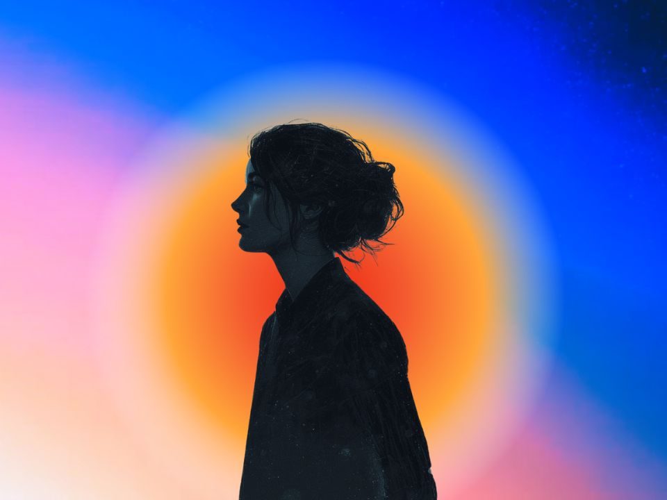 The silhouette of a young woman with an orange color aura on a pink and blue background.