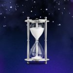 An hourglass filled with sand, set against a vibrant purple background, symbolizing the passage of time.