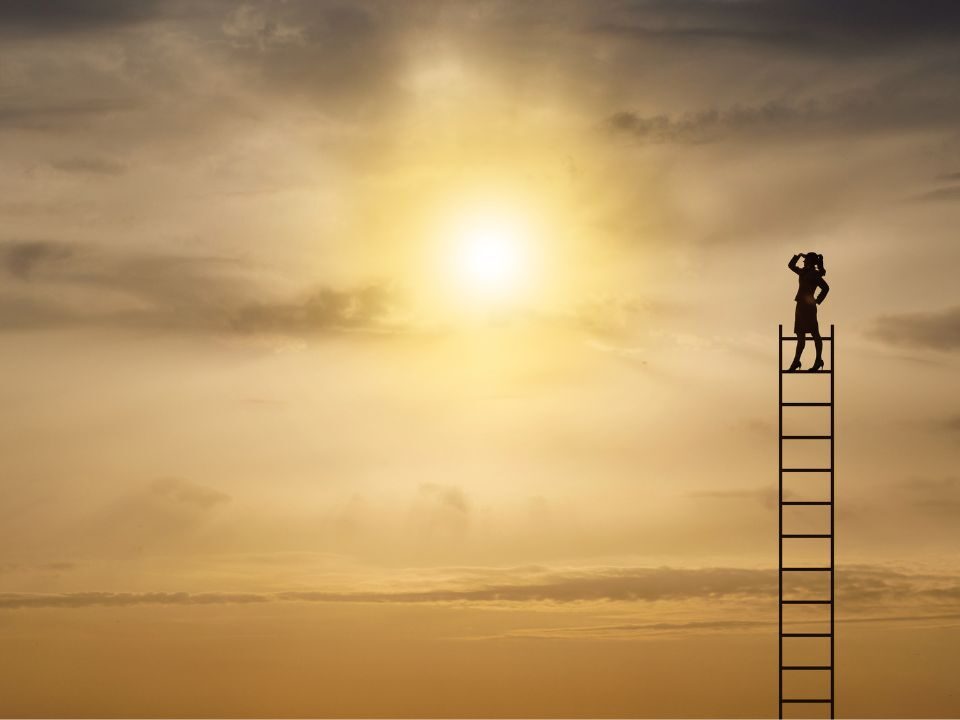 An individual on a ladder looks up at the sun, representing a pursuit of enlightenment and higher aspirations.