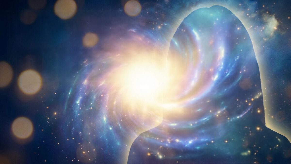 A person stands illuminated by the bright light of their soul, casting a strong glow around them in a dark cosmic environment.